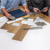 Two people looking at flooring samples on a table