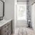 Apartment bathroom with Texas White Ash in 24” x 6” herringbone planks from Good Bones season 8 episode 8; photo credit: Cory Phillips, The Home Aesthetic