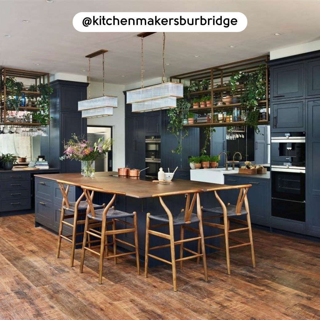 Antique French Oak RKP8110 floors in a kitchen with dark blue cabinets; photo credit: @kitchenmakersburbridge